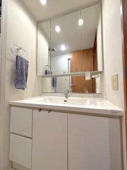 3面鏡が備わった洗面化粧台。ボウルとカウンターはお手入れのしやすい一体型です。